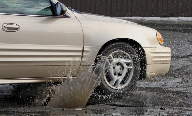 Car-Driving-Over-Pothole