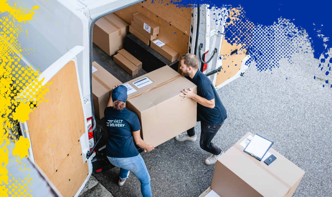 Workers loading a large box into a commercial van.