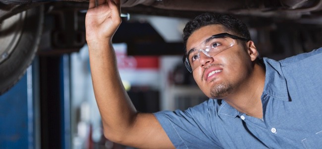 mechanic-inspecting-car-undercarriage Mechanic inspecting car underbody