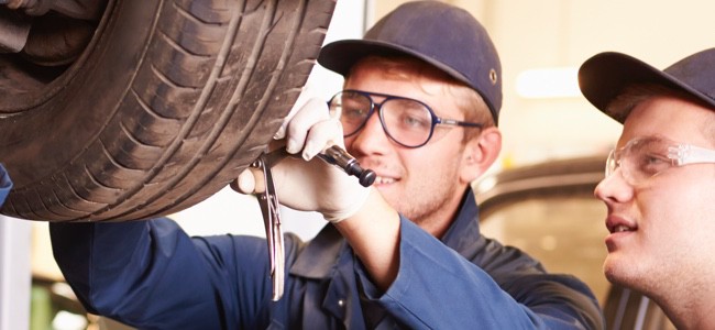 Technicians working on a tire