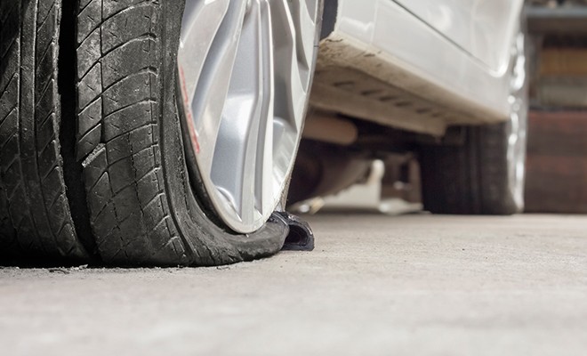 Flat-Tire-on-Car-In-Garage