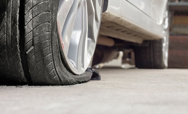 Flat-Tire-on-Car-In-Garage Flat-Tire-on-Car-In-Garage