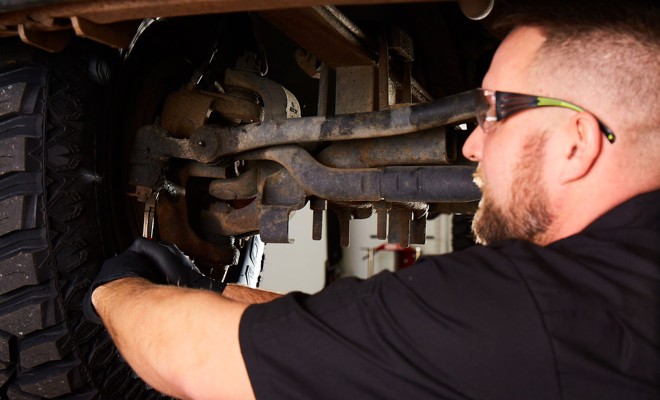 mechanic-working-on-suspension mechanic-working-on-suspension