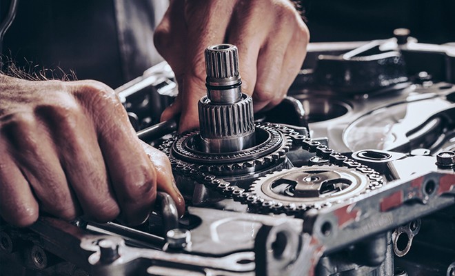 Mechanic working on engine transmission