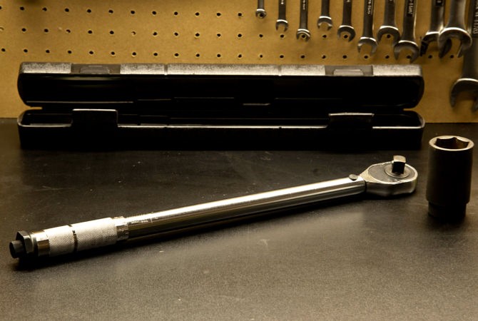 Torque wrench on workshop bench.