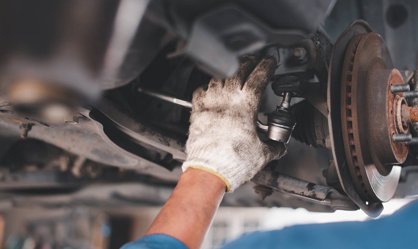 Auto-Technican-Working-On-Vehicle-Control-Arm
