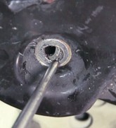 aligning-bushing-sleeve-to-bolt-hole Technician aligning the bushing sleeve to the hole.