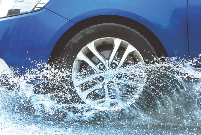 Car driving through puddle