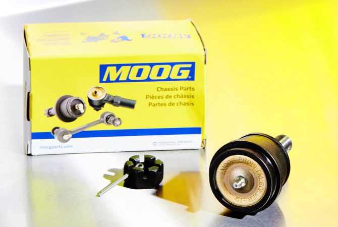 A MOOG chassis parts box next to a MOOG ball joint